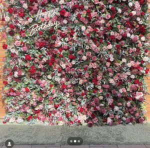 A bunch of roses used as background and has happy birthday sign on it.